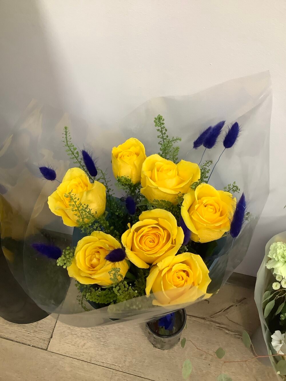 7 Yellow Roses with 11 Blue Accents